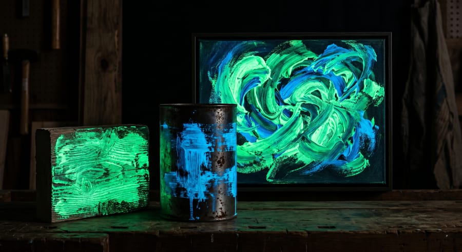 Glow in the dark paint glowing on multiple surfaces in a dark environment