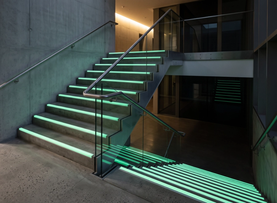 Photorealistic modern commercial staircase with premium aluminium glow in the dark stair nosings installed neatly along each step
